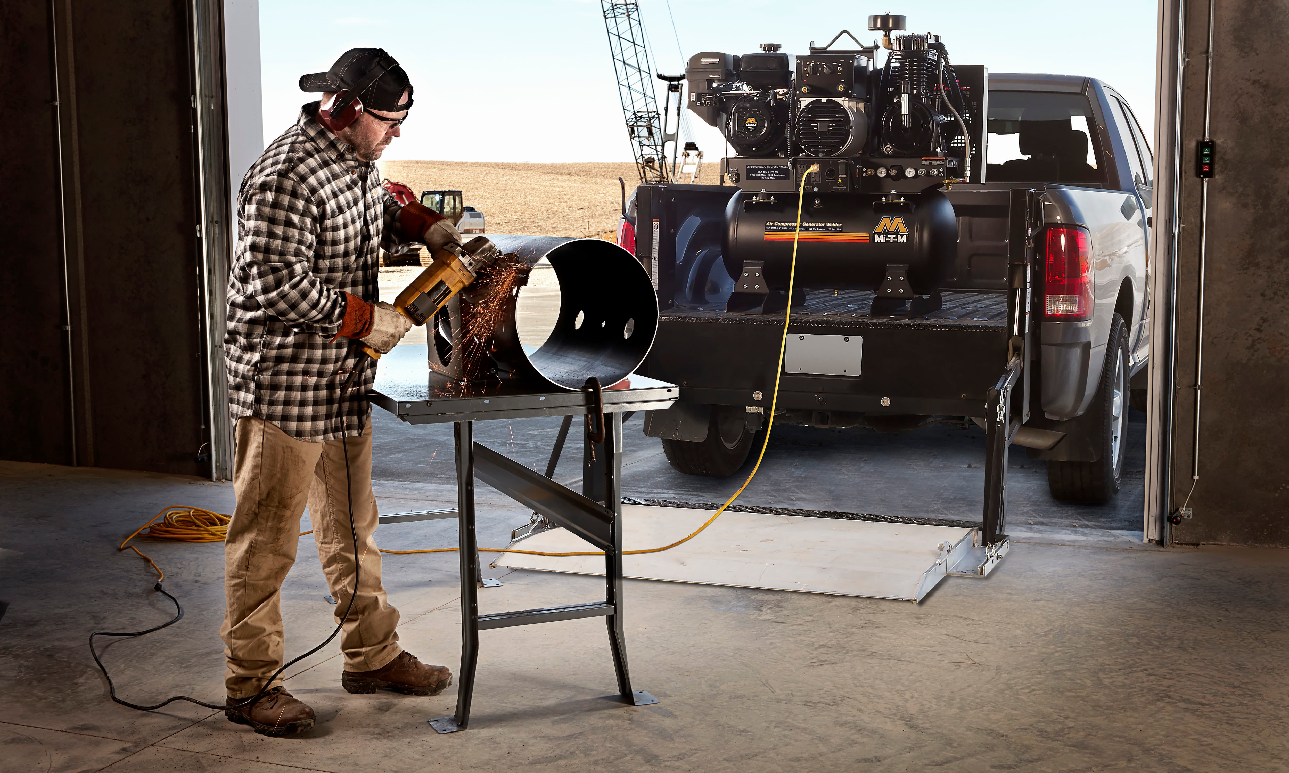 Man standing next to Mi-T-M Equipment